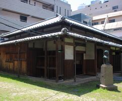 Exterior view of the former residence with a bust of Mori in front of it